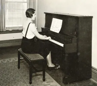 woman playing piano on campus