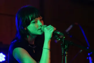 young woman singing during battle of the bands